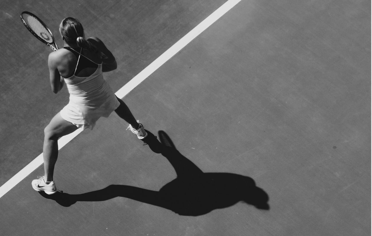 Tennis player casting dramatic shadow